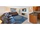 Large living space features a leather sofa, decorative rug, and open access to the kitchen at 1159 19Th Sw Ave, Largo, FL 33778