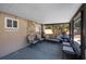 Covered patio with comfortable seating, stone accent wall, and pool view at 1159 19Th Sw Ave, Largo, FL 33778
