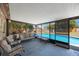 Enclosed patio with ample seating overlooking refreshing pool and fenced yard at 1159 19Th Sw Ave, Largo, FL 33778