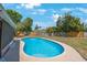 Private pool is surrounded by a well-maintained yard and tall wood fence at 1159 19Th Sw Ave, Largo, FL 33778