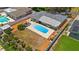 Aerial view of backyard with pool, patio, lush landscaping, and privacy fence at 12453 138Th N St, Largo, FL 33774