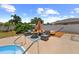 Outdoor living area featuring an outdoor fire pit with comfortable seating and an inviting hammock at 12453 138Th N St, Largo, FL 33774