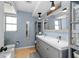 Bathroom showcasing a dual sink vanity, blue walls, and hardwood flooring at 12453 138Th N St, Largo, FL 33774