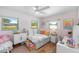 Cozy bedroom featuring a comfortable bed, natural light, and charming decor at 12453 138Th N St, Largo, FL 33774