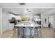 Bright kitchen with white cabinetry, stainless steel appliances, a breakfast bar, and modern pendant lighting at 12453 138Th N St, Largo, FL 33774