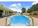 Backyard pool area with a sparkling pool, covered patio, and lush landscaping at 12453 138Th N St, Largo, FL 33774
