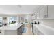 Spacious kitchen featuring stainless steel appliances, ample counter space, and modern white cabinetry at 12724 Tannencrest Dr, Riverview, FL 33579