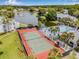 A scenic aerial view highlighting the community's tennis court, pool, and surrounding landscape at 1281 Pine Ridge E Cir # H1, Tarpon Springs, FL 34688