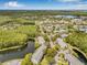 Beautiful aerial view of the home's location in a community near a pond and plenty of lush greenery at 1281 Pine Ridge E Cir # H1, Tarpon Springs, FL 34688