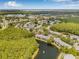 Overhead view of the home near a lake, surrounded by mature trees and manicured landscaping at 1281 Pine Ridge E Cir # H1, Tarpon Springs, FL 34688