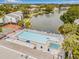 An aerial perspective showcasing the community pool, lake, and beautifully landscaped surroundings at 1281 Pine Ridge E Cir # H1, Tarpon Springs, FL 34688