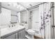 Bathroom featuring floral shower curtain, grey vanity with mirror, and shower at 1281 Pine Ridge E Cir # H1, Tarpon Springs, FL 34688