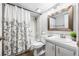 Bright bathroom featuring a white vanity, light grey walls, and a bathtub shower at 1281 Pine Ridge E Cir # H1, Tarpon Springs, FL 34688