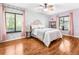 Comfortable bedroom with hardwood floors, ample natural light, and stylish decor at 1281 Pine Ridge E Cir # H1, Tarpon Springs, FL 34688