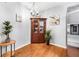 Cozy dining area with a wooden hutch, chandelier, hardwood floors, and stainless steel fridge at 1281 Pine Ridge E Cir # H1, Tarpon Springs, FL 34688