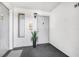 Well lit condo entrance with fresh white walls and new carpet at 1281 Pine Ridge E Cir # H1, Tarpon Springs, FL 34688