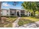 Charming two-story condo featuring a beautifully landscaped lawn and screened-in balconies at 1281 Pine Ridge E Cir # H1, Tarpon Springs, FL 34688