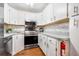 Modern kitchen featuring stainless steel appliances, white cabinetry, and hardwood floors at 1281 Pine Ridge E Cir # H1, Tarpon Springs, FL 34688