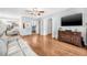 Spacious living room featuring hardwood floors, a ceiling fan, and sliding glass doors at 1281 Pine Ridge E Cir # H1, Tarpon Springs, FL 34688