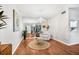 Bright living room featuring hardwood floors, mirror wall, and decorative chandelier at 1281 Pine Ridge E Cir # H1, Tarpon Springs, FL 34688