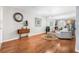 Bright living room featuring hardwood floors, mirror wall, and decorative chandelier at 1281 Pine Ridge E Cir # H1, Tarpon Springs, FL 34688