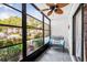 Relaxing screened porch with tiled floor, ceiling fan, and comfortable seating overlooking lush greenery at 1281 Pine Ridge E Cir # H1, Tarpon Springs, FL 34688