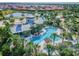 Aerial view showcasing a Primary-planned community with a pool, clubhouse, and beautiful landscaping by a lake at 13357 Waterleaf Garden Cir, Riverview, FL 33579