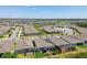 Lovely aerial of neighborhood homes featuring screened-in patios, solar panels and well-maintained landscaping at 13357 Waterleaf Garden Cir, Riverview, FL 33579