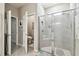 Bathroom showcasing glass-enclosed shower with tile surround, and open door to the toilet at 13357 Waterleaf Garden Cir, Riverview, FL 33579
