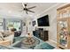 Cozy living room featuring a ceiling fan, large screen tv, and comfortable seating at 13357 Waterleaf Garden Cir, Riverview, FL 33579