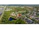 An aerial view showing the home situated among lush greenery, other houses, and nearby roads at 14019 Nighthawk Ter, Lakewood Ranch, FL 34202