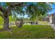 Backyard featuring a tranquil pond view and a comfortable hanging chair under a tree at 14019 Nighthawk Ter, Lakewood Ranch, FL 34202