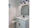 Bright bathroom featuring a white vanity with modern fixtures and a framed mirror at 14019 Nighthawk Ter, Lakewood Ranch, FL 34202