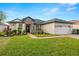 Charming single-story home with manicured lawn, stone accents, and a two-car garage at 14019 Nighthawk Ter, Lakewood Ranch, FL 34202