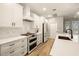Beautiful white kitchen featuring stainless steel appliances and white countertops at 14019 Nighthawk Ter, Lakewood Ranch, FL 34202