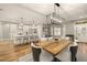 Open-concept living space with hardwood floors and large windows at 14019 Nighthawk Ter, Lakewood Ranch, FL 34202