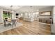 Open-concept living space with hardwood floors and large windows at 14019 Nighthawk Ter, Lakewood Ranch, FL 34202