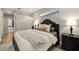 A spacious main bedroom with a black bed frame, natural light, and neutral decor at 14019 Nighthawk Ter, Lakewood Ranch, FL 34202