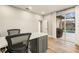 Office with pool views through sliding glass door, providing relaxation at 14019 Nighthawk Ter, Lakewood Ranch, FL 34202