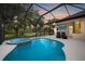 Beautiful pool with a spa, lush landscaping, and a fire pit area in the backyard at 14019 Nighthawk Ter, Lakewood Ranch, FL 34202