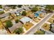 Overhead view of house featuring roof and nearby neighborhood with cars parked on the side of the road at 1408 Dartmouth Dr, Holiday, FL 34691