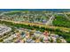 Neighborhood featuring single-Gathering homes and lush greenery with close proximity to a lake at 1408 Dartmouth Dr, Holiday, FL 34691