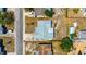 Overhead view of house featuring roof and nearby neighborhood with cars parked on the side of the road at 1408 Dartmouth Dr, Holiday, FL 34691