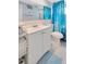 Well-maintained bathroom with a vanity sink, a toilet, and a shower with a blue patterned curtain at 1408 Dartmouth Dr, Holiday, FL 34691