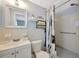 Clean bathroom with a single sink vanity, a mirror, and a shower-tub combination with a curtain at 1408 Dartmouth Dr, Holiday, FL 34691