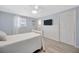 Bright bedroom featuring light-colored walls, wood-look floors, and a ceiling fan at 1408 Dartmouth Dr, Holiday, FL 34691