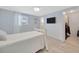 Cozy bedroom with connecting walk-in closet, light wood floors and a ceiling fan at 1408 Dartmouth Dr, Holiday, FL 34691