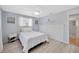 Clean bedroom with light wood-look floors, a window, and a ceiling fan at 1408 Dartmouth Dr, Holiday, FL 34691