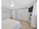 Bright bedroom featuring light-colored walls, wood-look floors, and a ceiling fan at 1408 Dartmouth Dr, Holiday, FL 34691