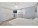 Well-lit bedroom with a ceiling fan, closet, and light wood-look floors at 1408 Dartmouth Dr, Holiday, FL 34691